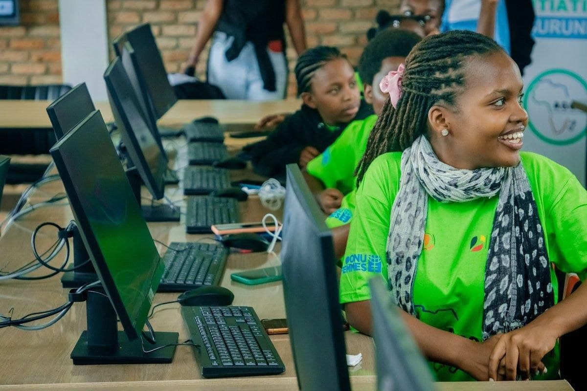Young women learning together at computers in a digital literacy classroom